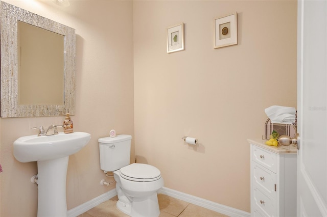 bathroom featuring sink, toilet, and tile patterned flooring