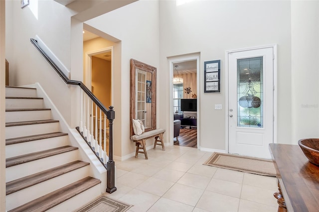 tiled foyer with a towering ceiling and plenty of natural light