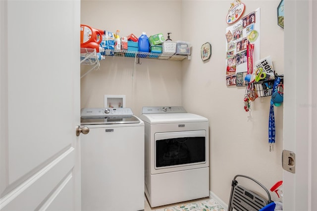 clothes washing area featuring separate washer and dryer