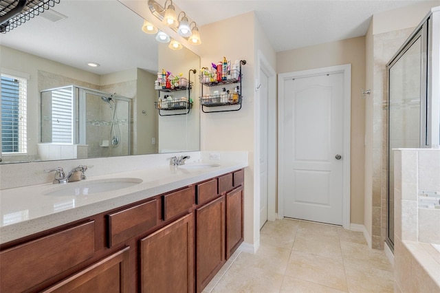 bathroom featuring vanity, tile patterned flooring, and walk in shower