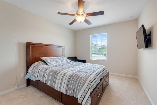 bedroom with ceiling fan and light colored carpet