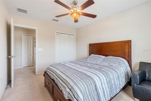 bedroom with a closet, ceiling fan, and light carpet