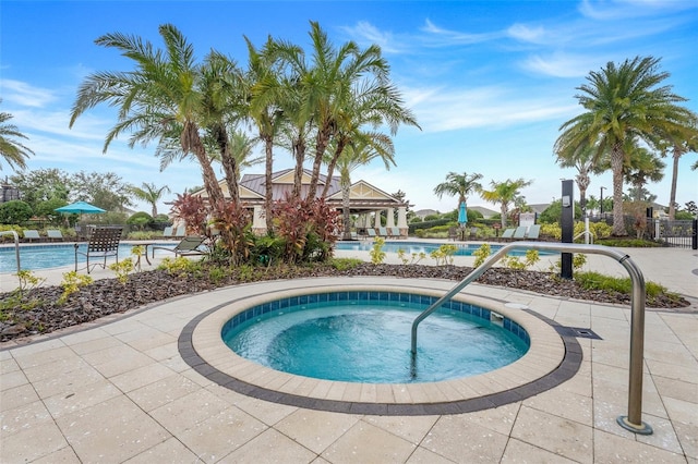 view of pool with a community hot tub