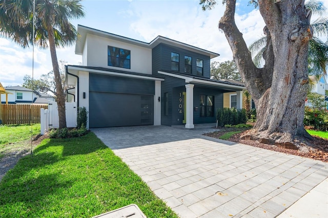 view of front of house with a garage and a front lawn