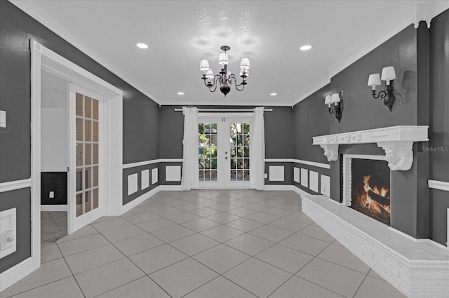 unfurnished living room with ornamental molding, a textured ceiling, light tile patterned floors, and a brick fireplace