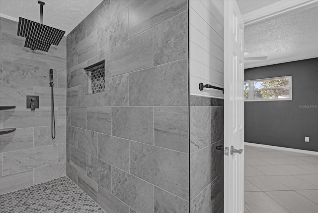 bathroom with a textured ceiling and tiled shower