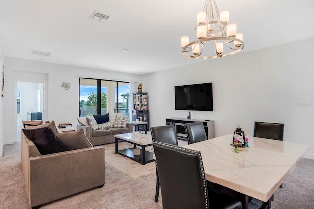 living room with visible vents, a chandelier, and light carpet