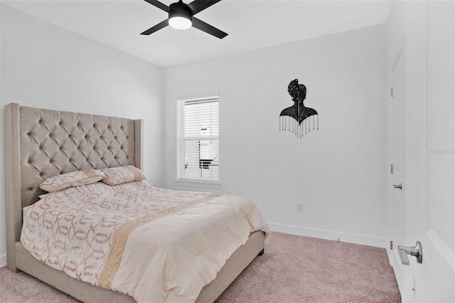 bedroom with a ceiling fan, baseboards, and carpet floors