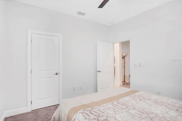 carpeted bedroom with visible vents and a ceiling fan