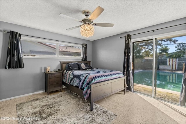 bedroom with ceiling fan, a textured ceiling, and access to exterior