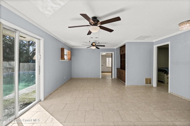 tiled empty room with crown molding, a textured ceiling, and ceiling fan