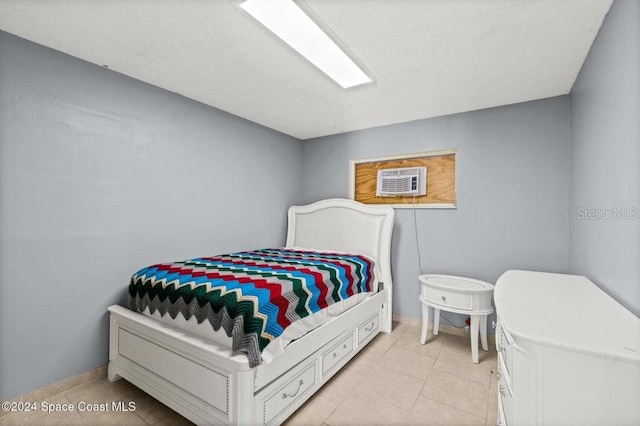 tiled bedroom with a wall mounted air conditioner and a textured ceiling