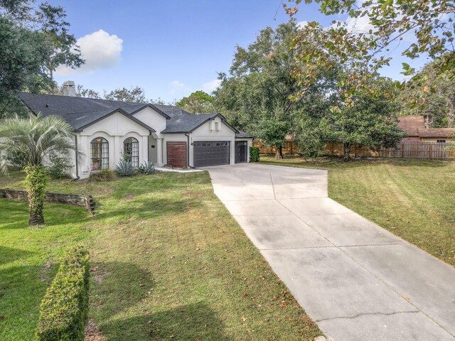 view of front of property featuring a garage and a front yard