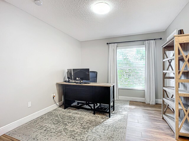 office space featuring hardwood / wood-style floors and a textured ceiling