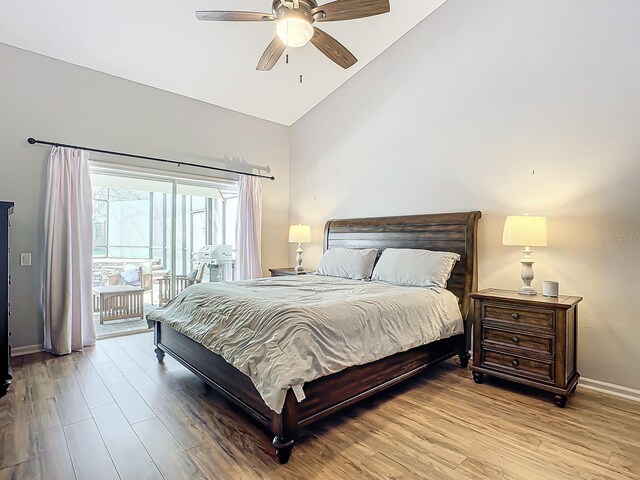 bedroom featuring access to exterior, high vaulted ceiling, light hardwood / wood-style flooring, and ceiling fan