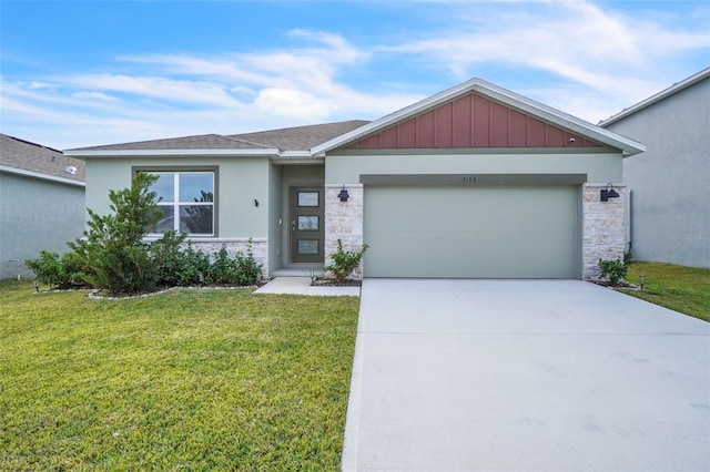 view of front of home featuring a front yard and a garage