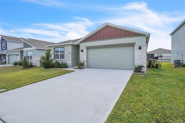 view of front facade featuring cooling unit, a garage, and a front lawn