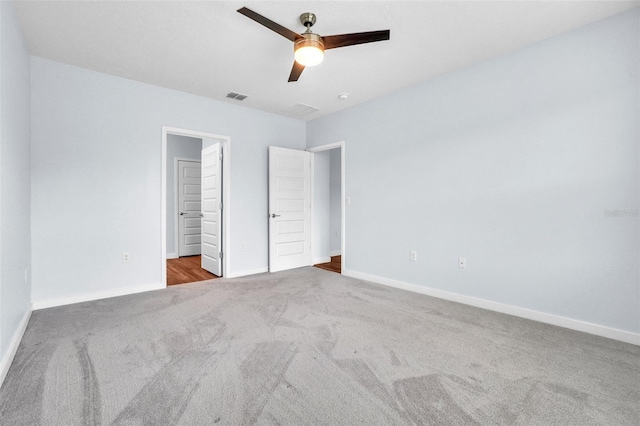 unfurnished bedroom with ceiling fan and light colored carpet