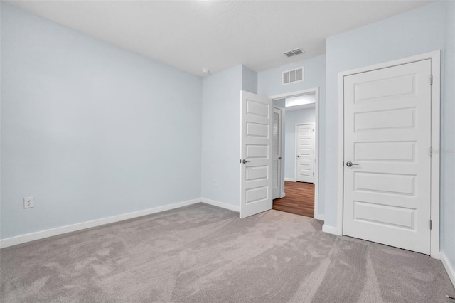 unfurnished bedroom featuring light carpet