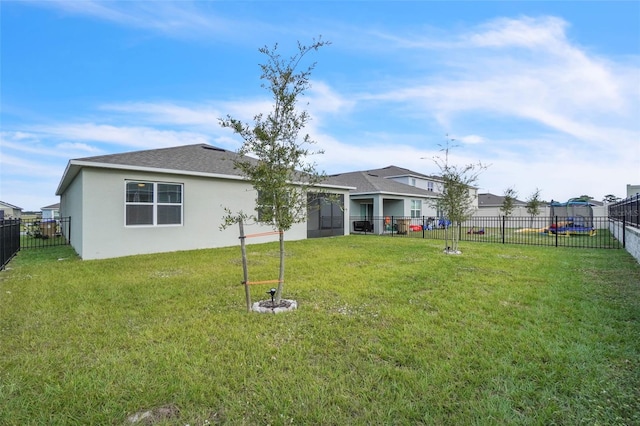 rear view of house featuring a yard