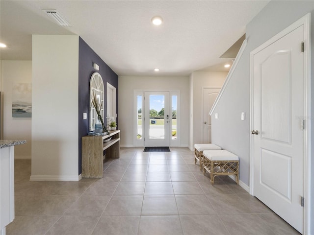 foyer entrance featuring light tile patterned floors