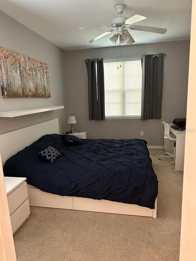 bedroom with ceiling fan and light carpet