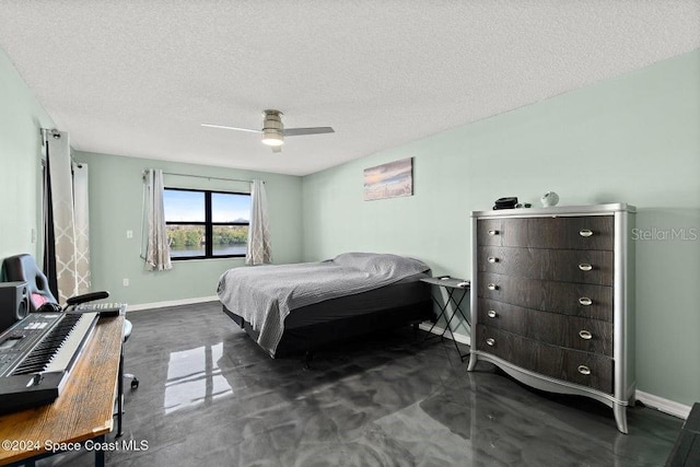 bedroom with ceiling fan and a textured ceiling