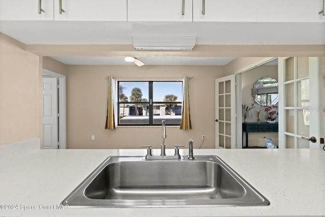 kitchen featuring white cabinetry and sink