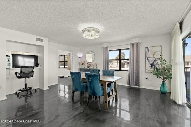 dining room featuring a textured ceiling