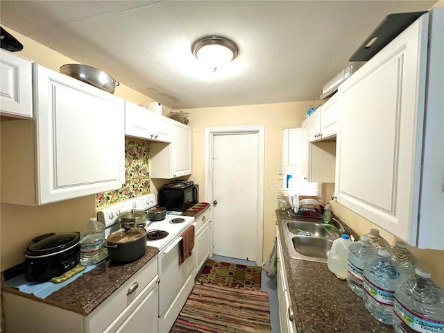 kitchen with white cabinetry, white electric range oven, sink, and dark stone counters