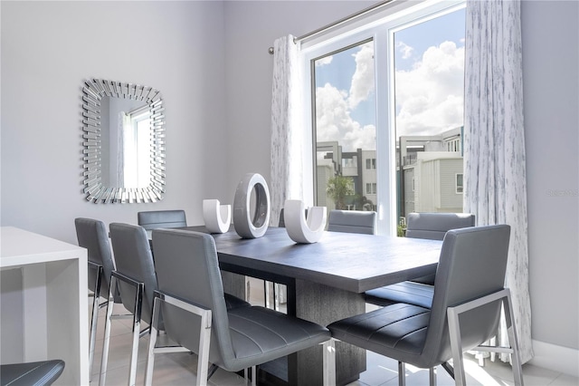 dining room featuring light tile patterned flooring and a wealth of natural light