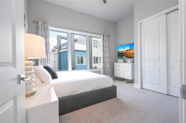 carpeted bedroom featuring a closet and ceiling fan