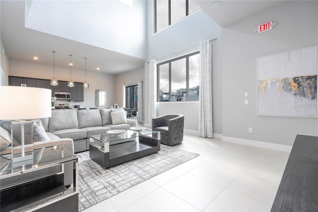 tiled living room with a towering ceiling