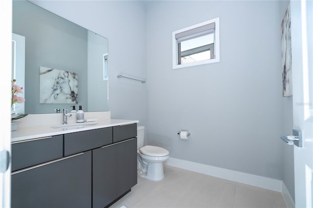 bathroom with vanity, toilet, and tile patterned flooring