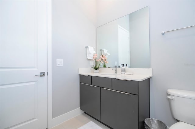 bathroom featuring vanity, toilet, and tile patterned floors