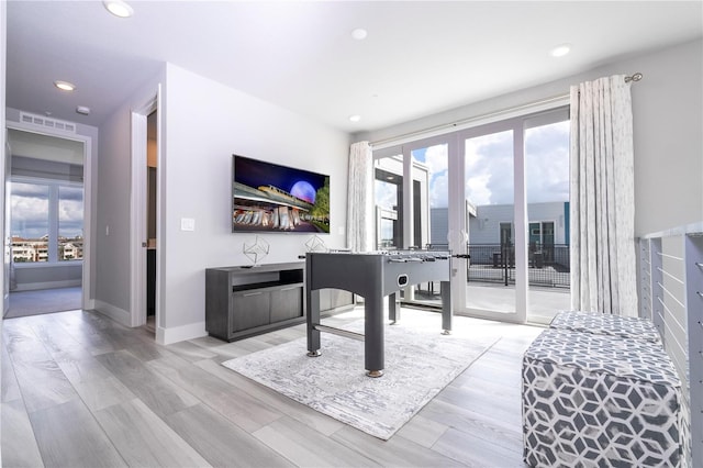 miscellaneous room with french doors and light hardwood / wood-style flooring