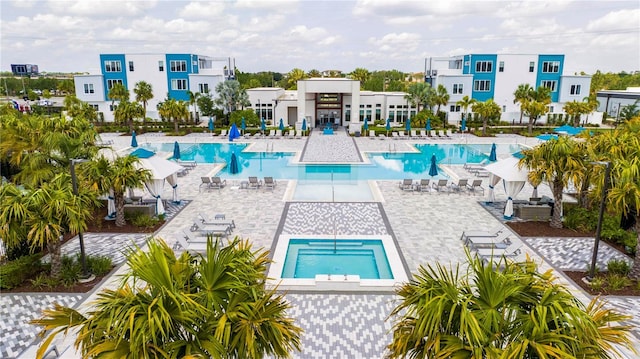 view of pool featuring a patio and a community hot tub