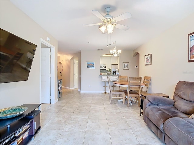 interior space with ceiling fan with notable chandelier and light tile patterned floors