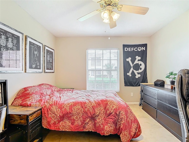 bedroom with ceiling fan and tile patterned floors