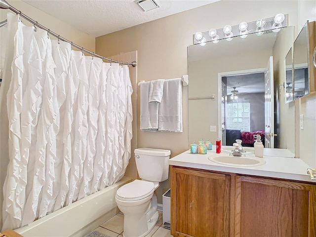 full bathroom with shower / bath combination with curtain, a textured ceiling, toilet, vanity, and tile patterned floors