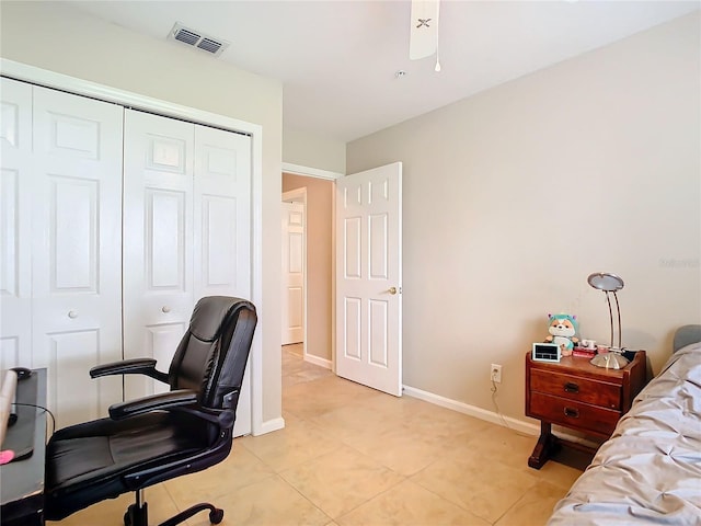 bedroom with a closet and light tile patterned flooring