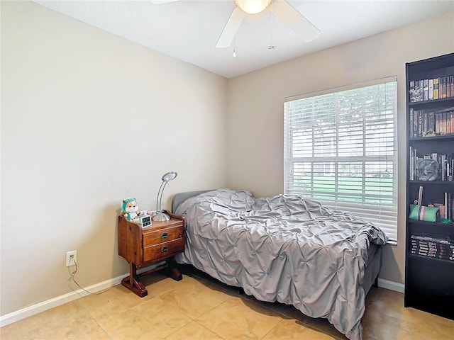 tiled bedroom featuring ceiling fan