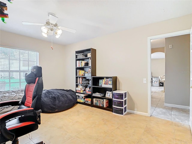 office featuring light tile patterned floors and ceiling fan