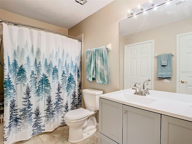 bathroom with vanity, toilet, and tile patterned flooring