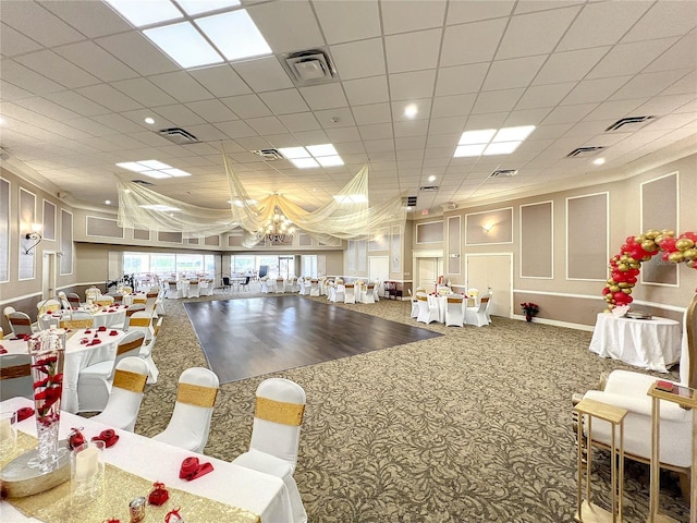 game room featuring an inviting chandelier and carpet flooring