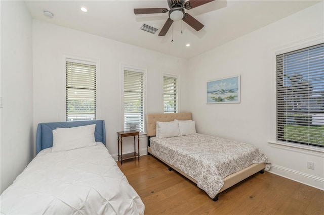 bedroom with ceiling fan and dark hardwood / wood-style floors