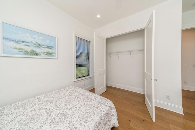 bedroom featuring hardwood / wood-style flooring and a closet