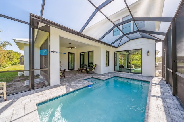 rear view of house with ceiling fan, a lanai, and a patio area