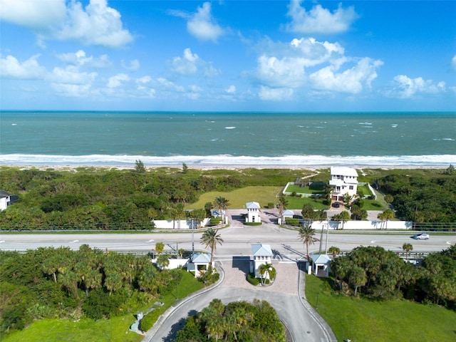 birds eye view of property with a water view and a beach view