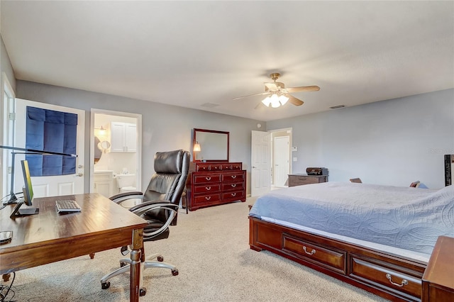 bedroom with ceiling fan, ensuite bath, and light colored carpet